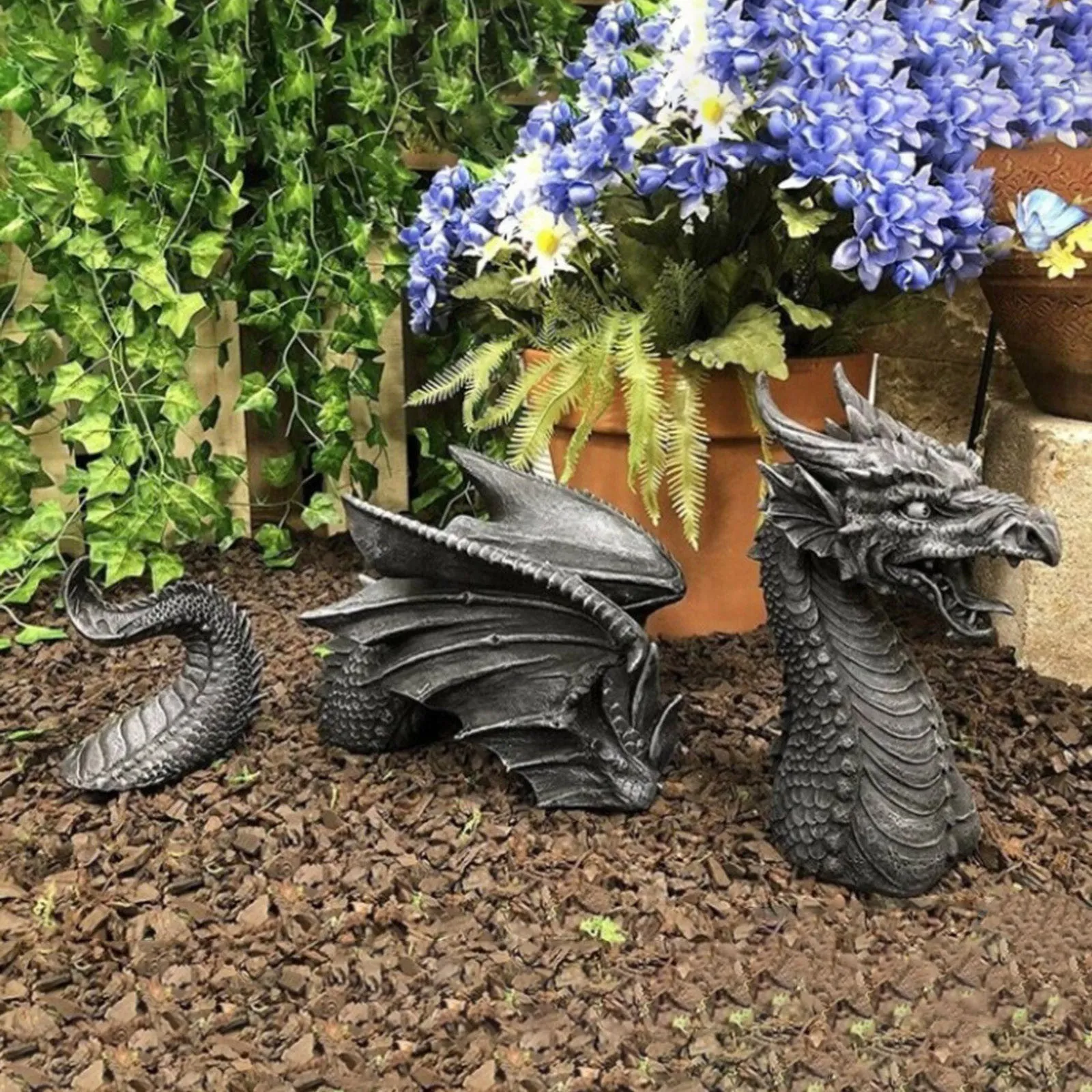Large gothic dragon garden statue in charcoal grey resin with wings and tail, placed on a lawn