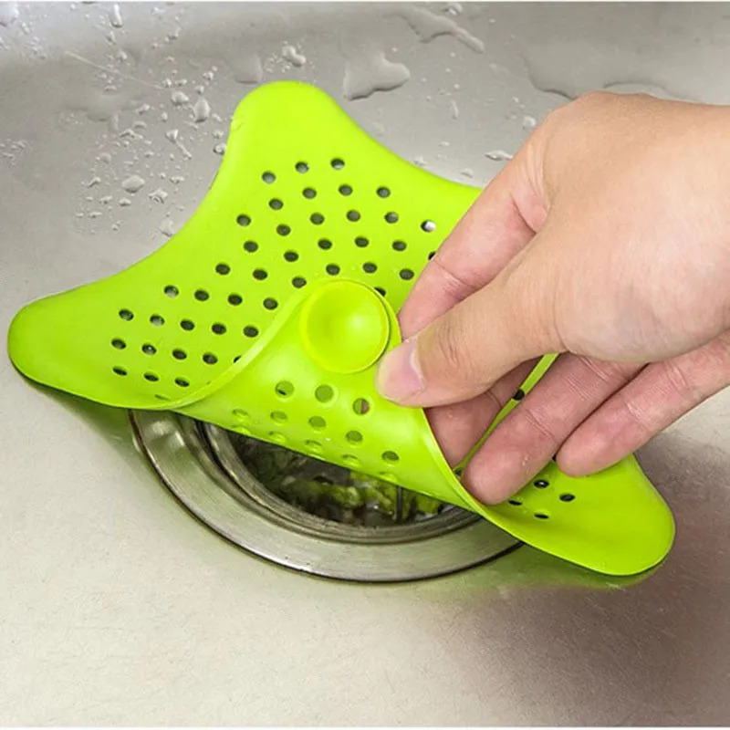 Three silicone starfish sink drain strainers in white, blue, and green with suction cups on bottom