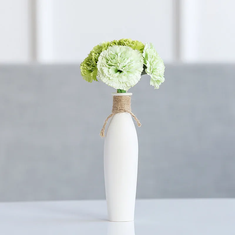 Modern simple ceramic vase with artificial dried flower arrangement on a countertop, medium size