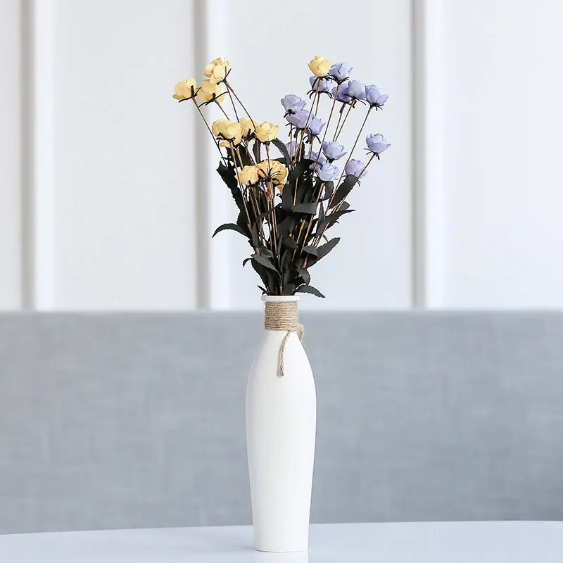 Modern simple ceramic vase with artificial dried flower arrangement on a countertop, medium size