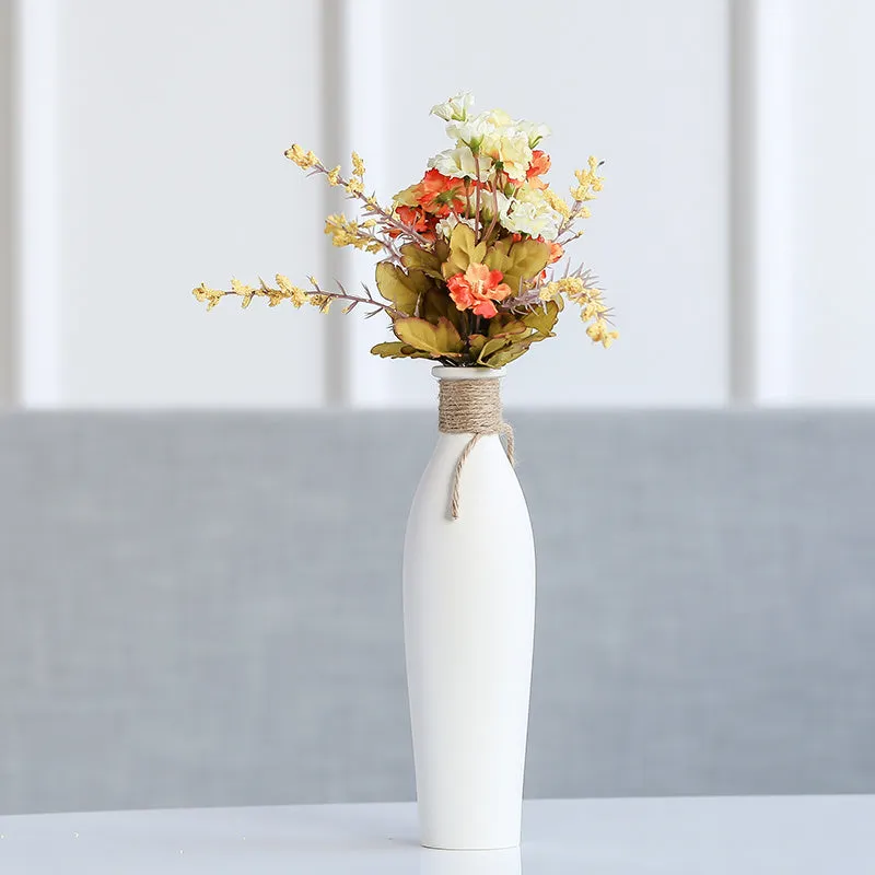 Modern simple ceramic vase with artificial dried flower arrangement on a countertop, medium size
