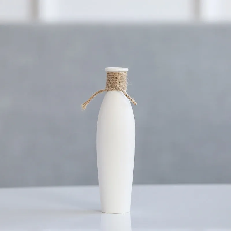 Modern simple ceramic vase with artificial dried flower arrangement on a countertop, medium size