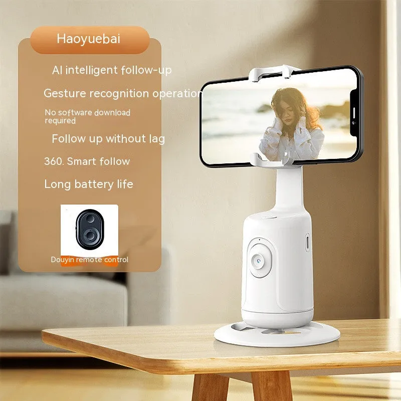 Automatic tracking stabiliser with 360-degree rotation in black, pink, and white on a desktop