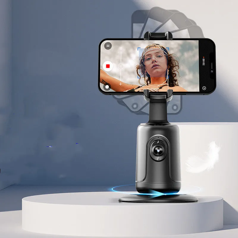 Automatic tracking stabiliser with 360-degree rotation in black, pink, and white on a desktop