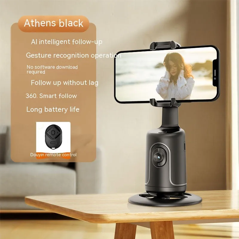 Automatic tracking stabiliser with 360-degree rotation in black, pink, and white on a desktop