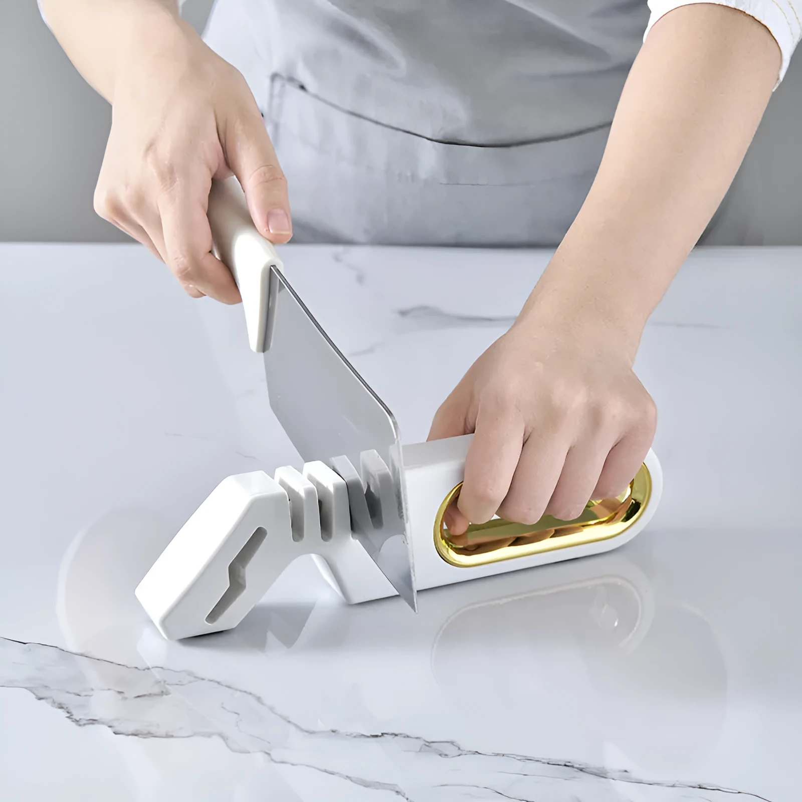 Four-in-one stone manual grinder for sharpening kitchen knives in pearl white colour, with ceramic and diamond stages visible