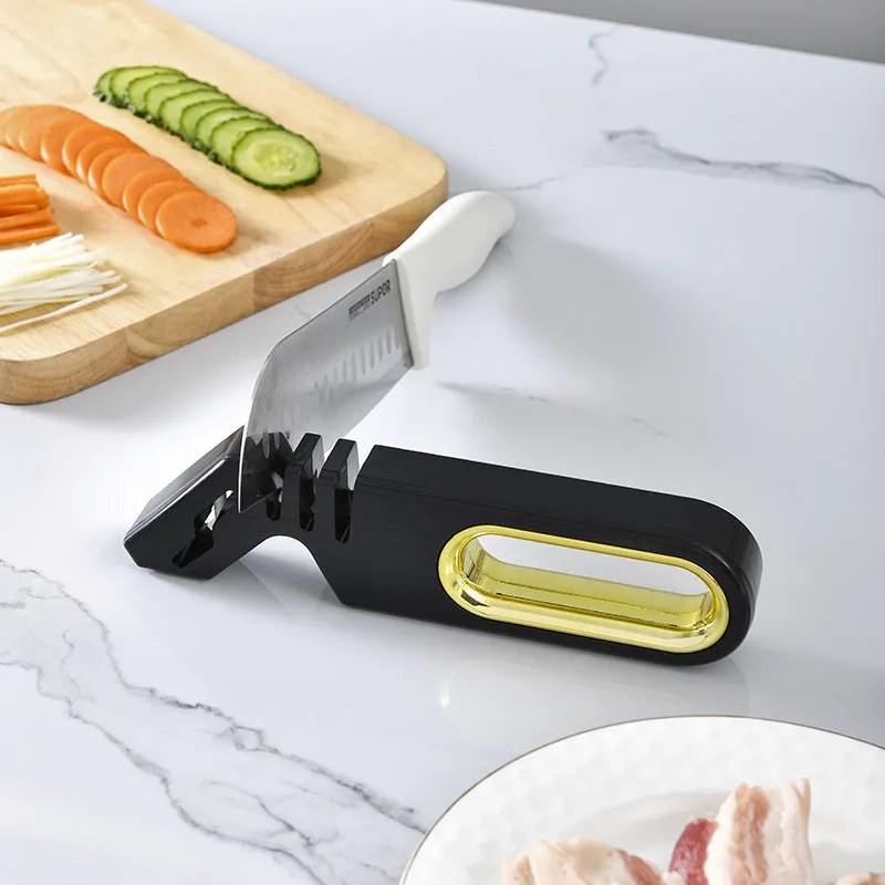 Four-in-one stone manual grinder for sharpening kitchen knives in pearl white colour, with ceramic and diamond stages visible