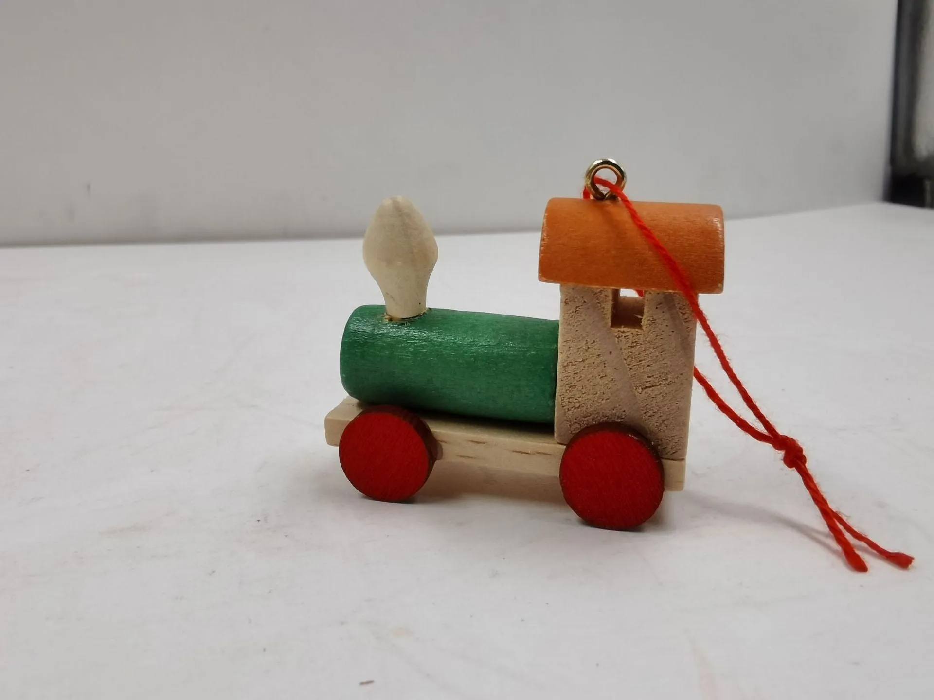 Handcrafted wooden Christmas train ornament in modern simple cartoon style, available in multiple colours