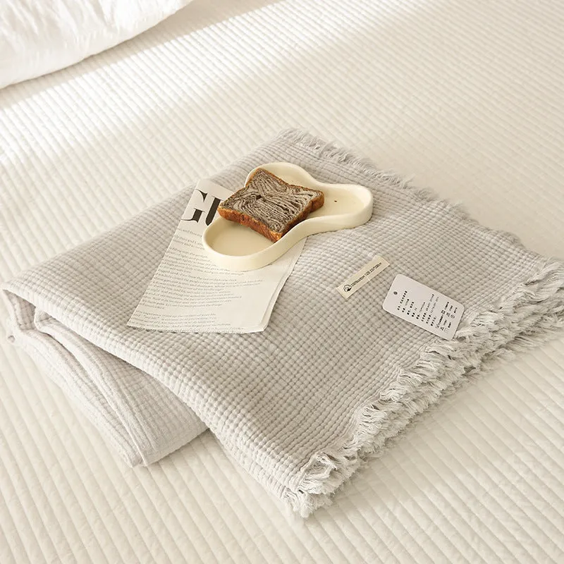 Four-layer cotton gauze blanket with tassel trim in navy blue colour