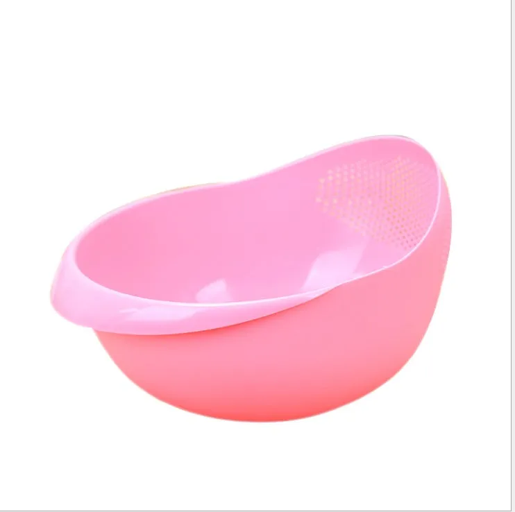 Plastic rice washing sieve in blue on a kitchen countertop with rice grains visible inside