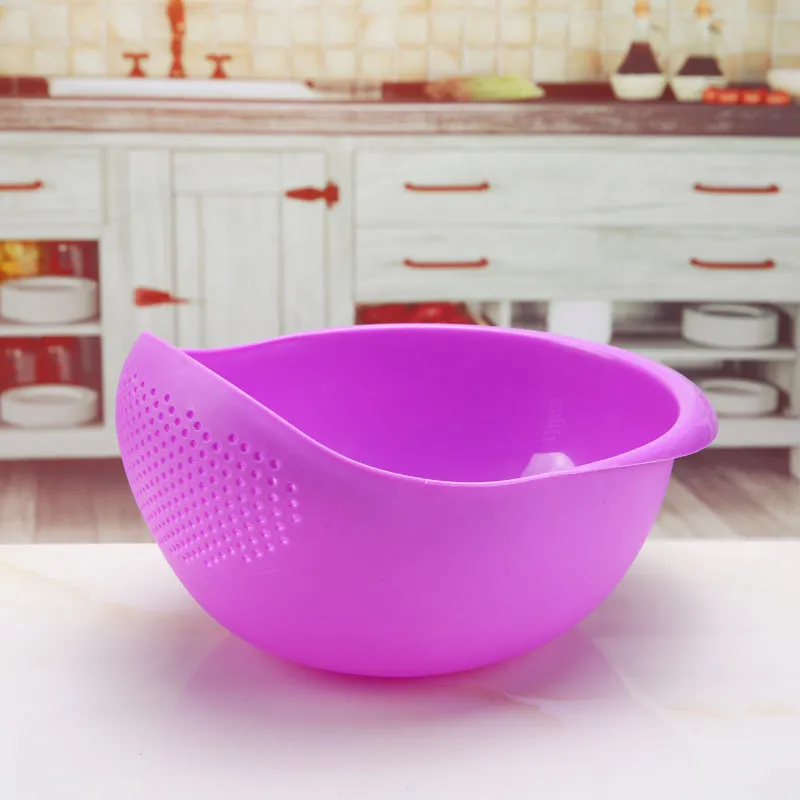 Plastic rice washing sieve in blue on a kitchen countertop with rice grains visible inside