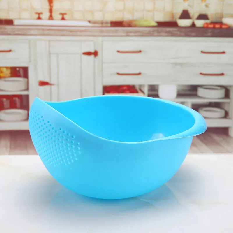 Plastic rice washing sieve in blue on a kitchen countertop with rice grains visible inside