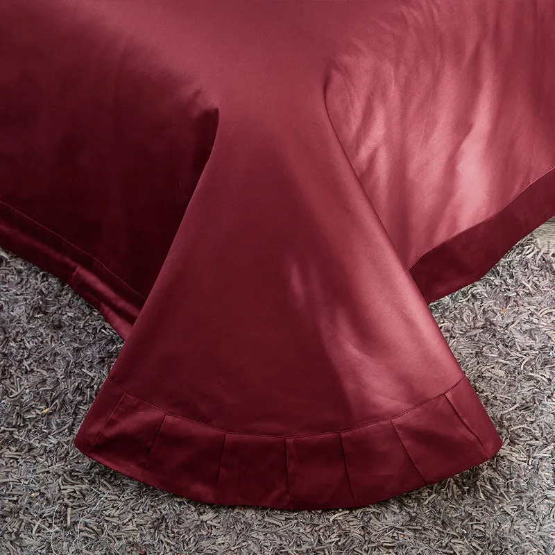 Four-piece cotton embroidery bed set in grey, comprising duvet cover, fitted sheet, and two pillowcases, satin weave finish