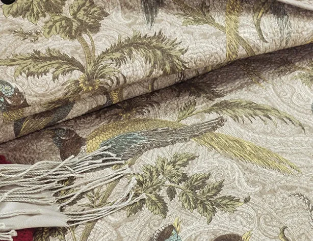 American-style floral quilted cotton bedspread in blue, shown draped on a double bed.
