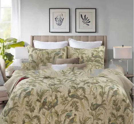 American-style floral quilted cotton bedspread in blue, shown draped on a double bed.