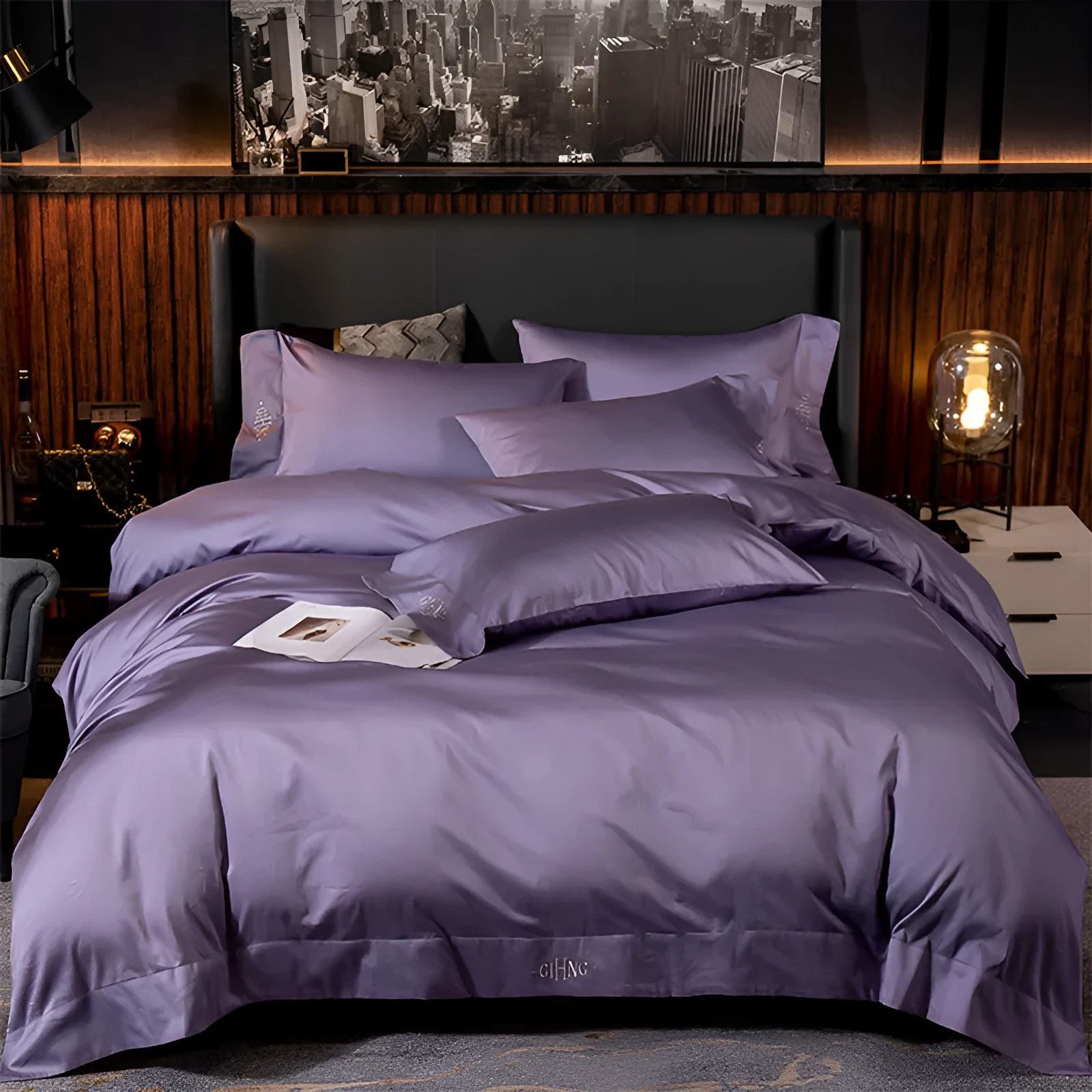 Four-piece cotton satin quilted bedding set with duvet cover, sheet, and pillowcases in a bedroom setting