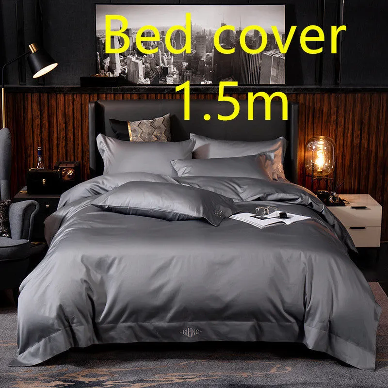 Four-piece cotton satin quilted bedding set with duvet cover, sheet, and pillowcases in a bedroom setting