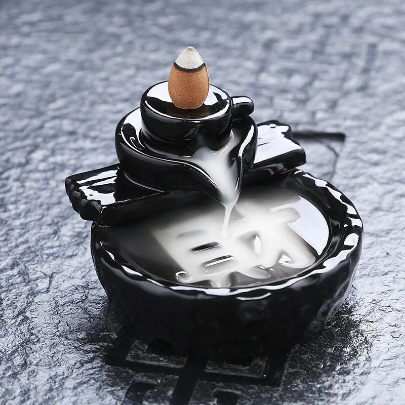 Ceramic backflow incense burner with black glaze finish and waterfall smoke effect