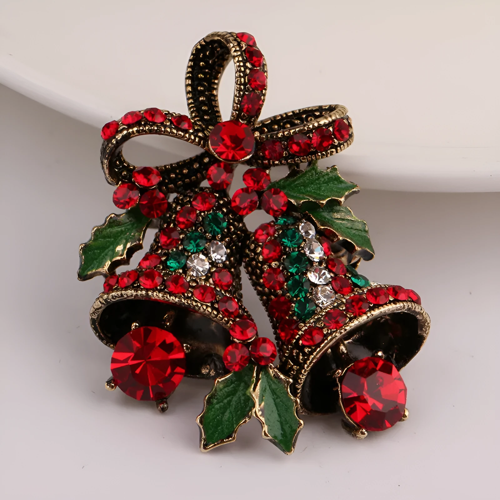 Christmas suit pin brooch in ancient gold with artificial gems, bell shape on alloy base