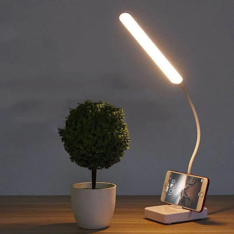 White USB charging folding LED desk lamp with touch switch and lithium battery on a desk