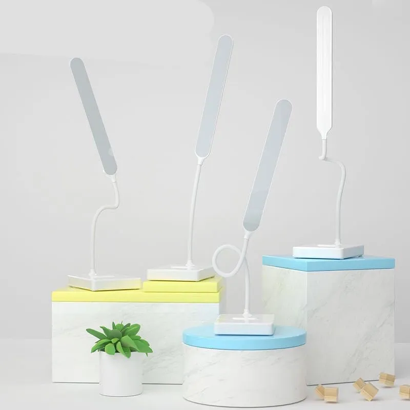 White USB charging folding LED desk lamp with touch switch and lithium battery on a desk