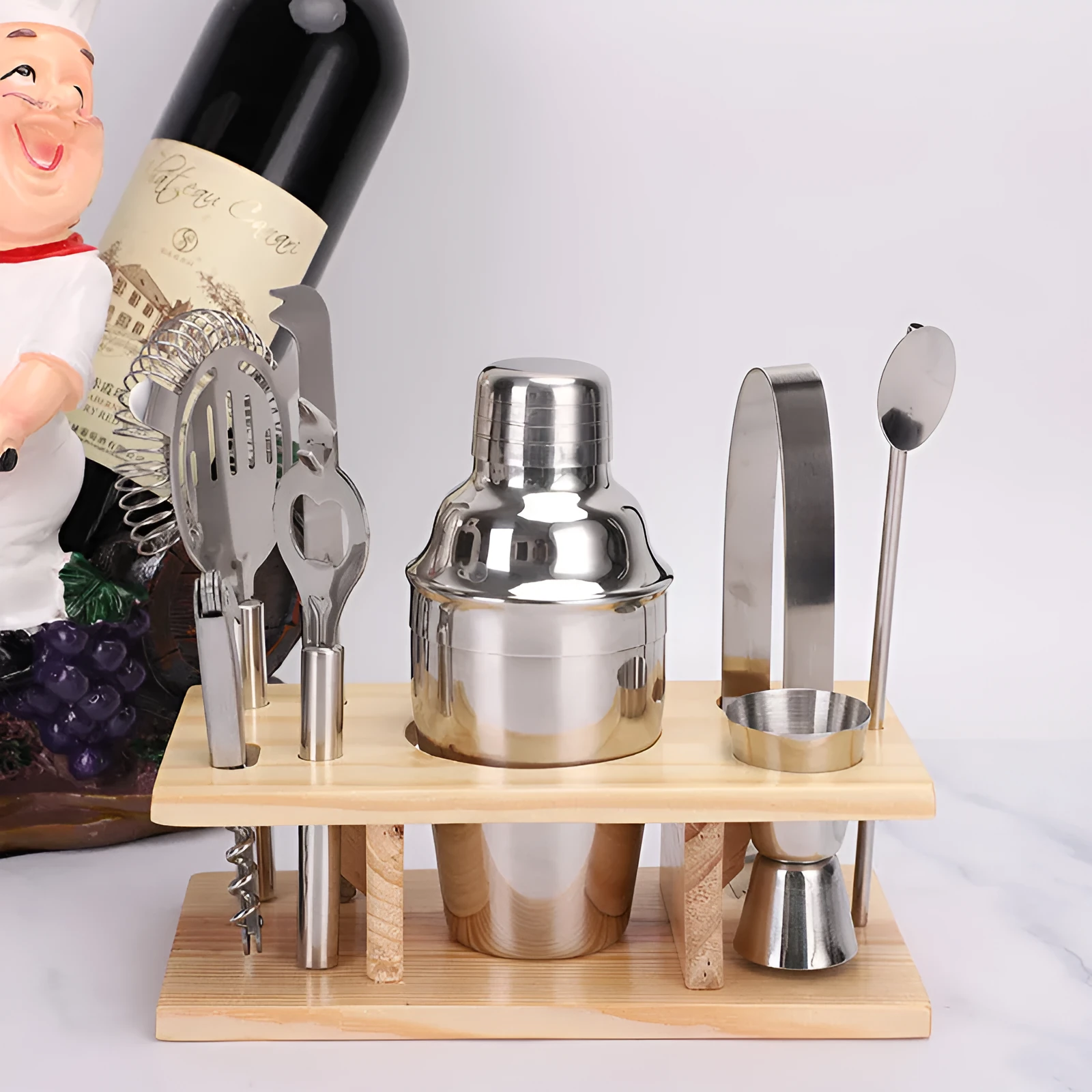 8pc stainless steel cocktail shaker set with graduated pieces on a table, various heights from 11cm to 18cm