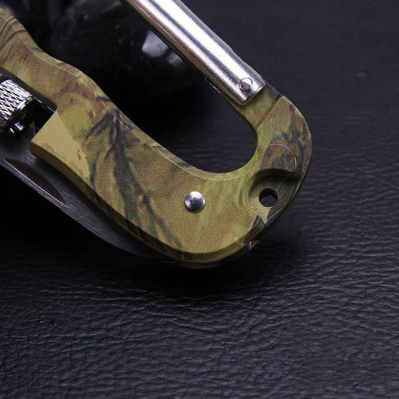 Camouflage multifunctional carabiner with knife, saw, and LED light on a black background