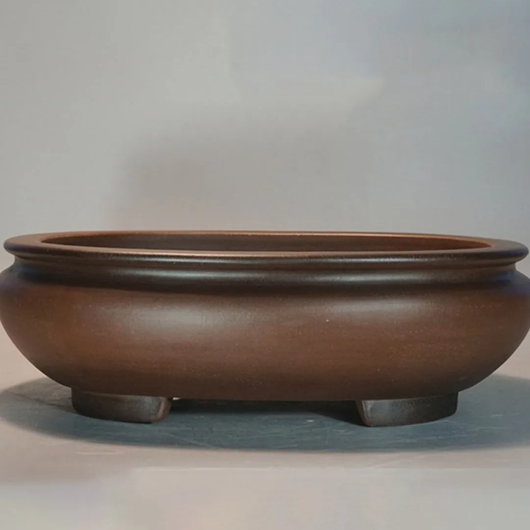 Handmade purple clay classical style desktop flowerpot on a wooden surface