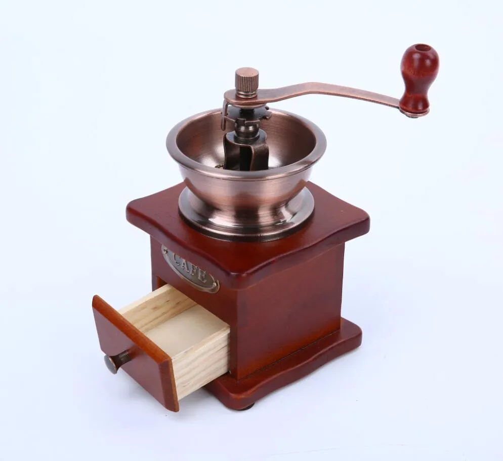 Red manual coffee grinder with ceramic burr and cast iron handle, 10x10x17cm, on a wooden surface