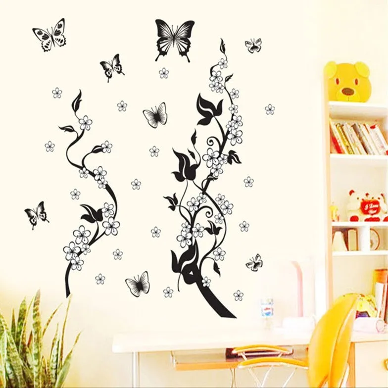 PVC wall sticker showing butterfly and flower design in photo colour on a white wall, size 50x70cm