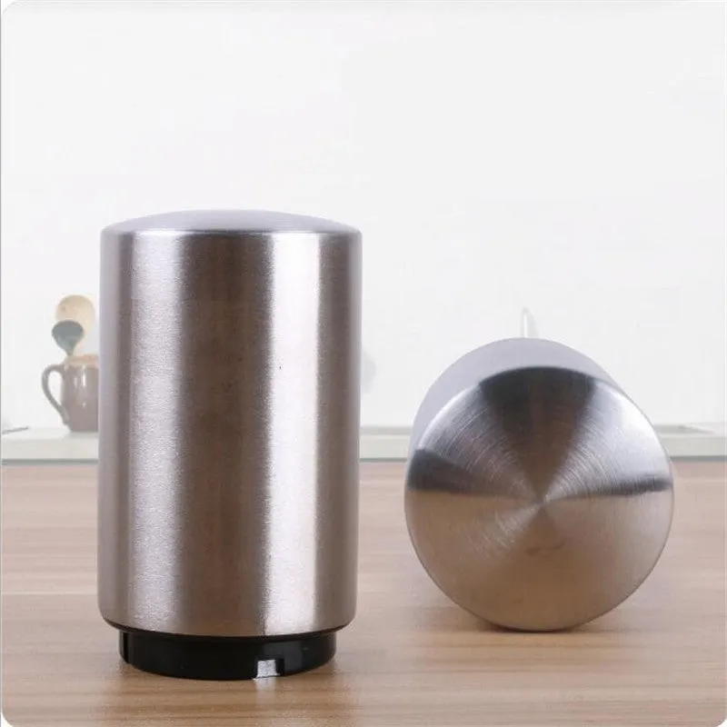 Silver magnetic automatic bottle opener with stainless steel body and brushed finish on kitchen countertop