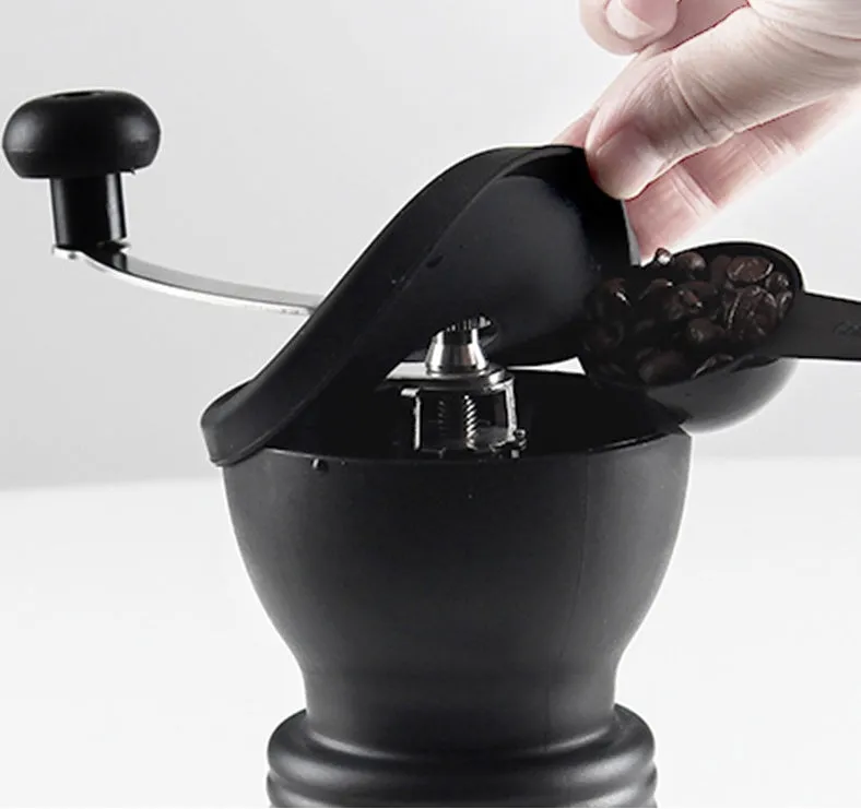 Beech wood hand grinder coffee machine with black finish, 88 mm wide, on a table