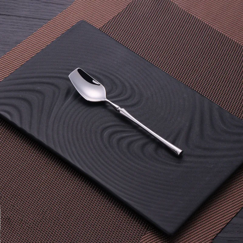 Stainless steel cutlery set with main knife, main fork, main spoon, and teaspoon in silver finish