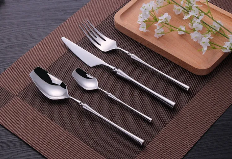 Stainless steel cutlery set with main knife, main fork, main spoon, and teaspoon in silver finish