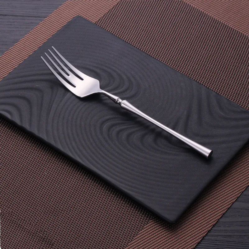 Stainless steel cutlery set with main knife, main fork, main spoon, and teaspoon in silver finish
