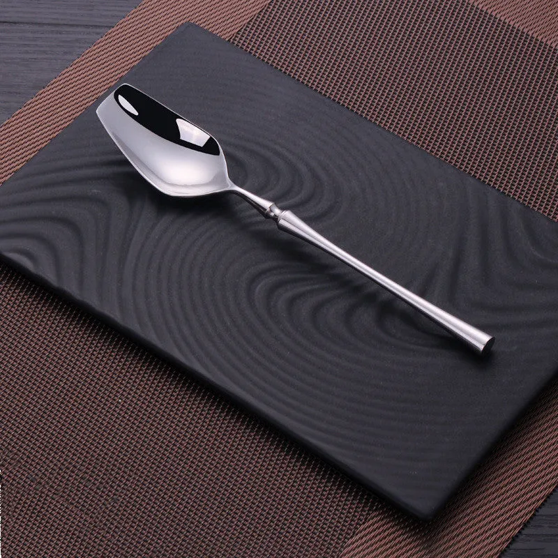 Stainless steel cutlery set with main knife, main fork, main spoon, and teaspoon in silver finish