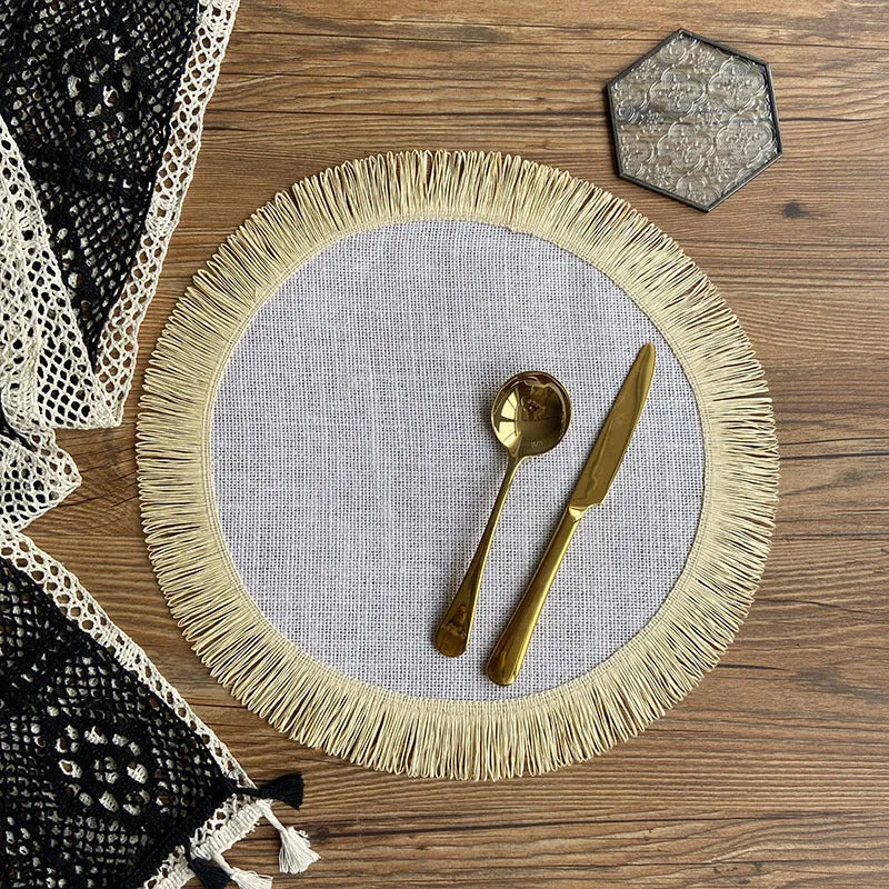 Handwoven round jute placemat with tassel edge in original hemp colour on a wooden table