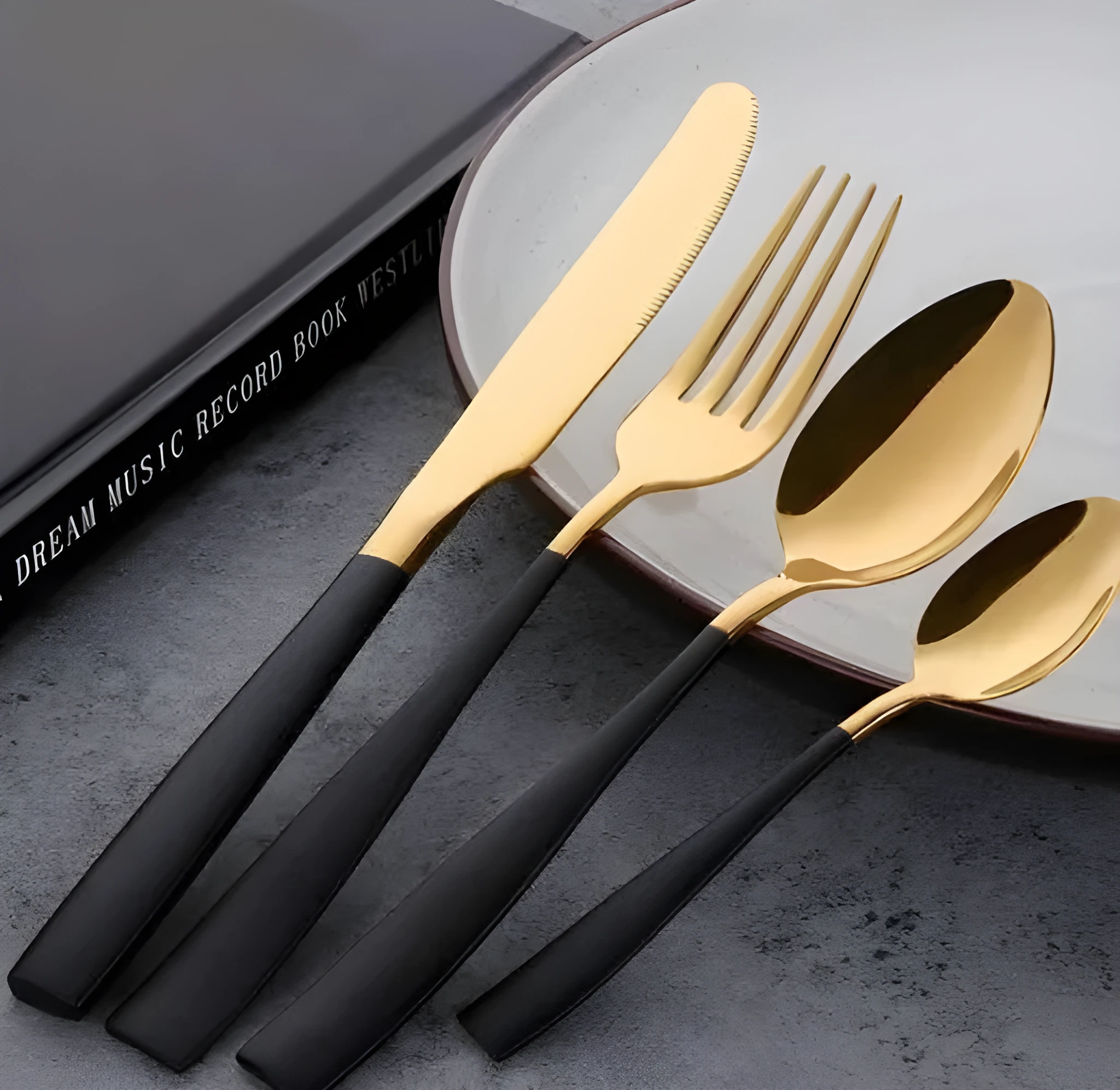 Four-piece stainless steel cutlery set in black with mirror polished finish
