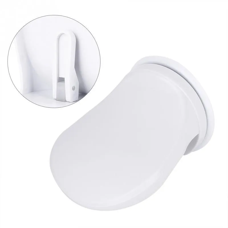 White plastic bathroom shower foot rest with suction cups on smooth tile
