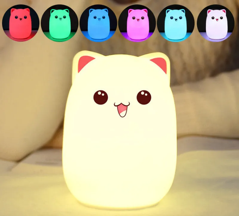 Cartoon silicone clap lamp in blue with warm white light mode on a wooden bedside table