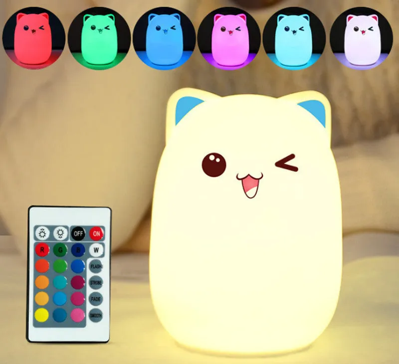 Cartoon silicone clap lamp in blue with warm white light mode on a wooden bedside table