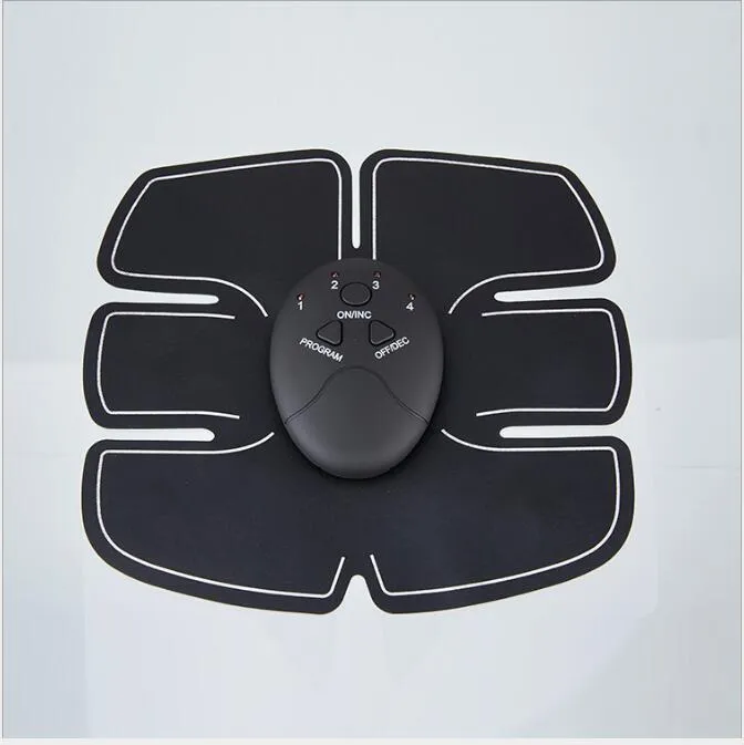 Black EMS muscle stimulator with electrode pads placed on abdomen for slimming and toning