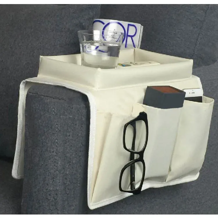 Black Oxford fabric sofa armrest organiser bag with 6 pockets on a couch handrail