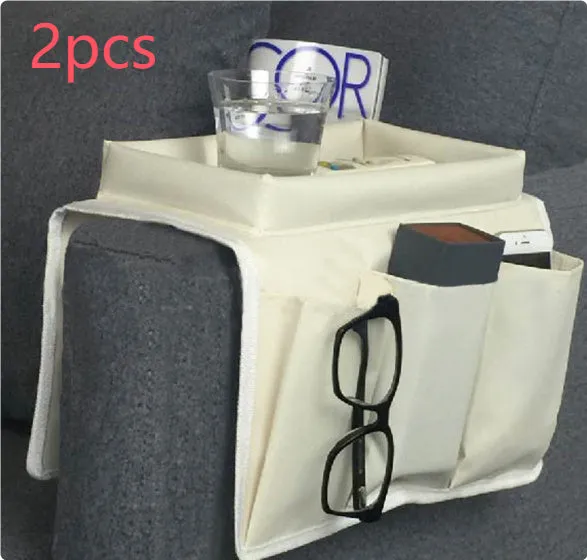 Black Oxford fabric sofa armrest organiser bag with 6 pockets on a couch handrail