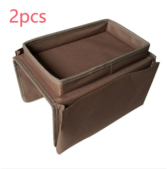 Black Oxford fabric sofa armrest organiser bag with 6 pockets on a couch handrail