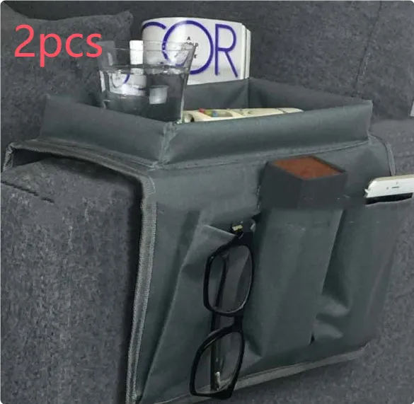 Black Oxford fabric sofa armrest organiser bag with 6 pockets on a couch handrail