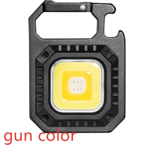 Black multifunctional portable LED torch with aluminium alloy body, magnet base, and control button on a wooden surface