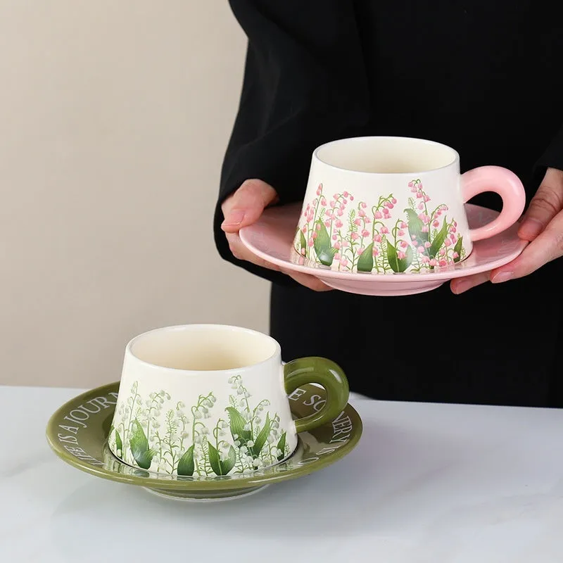 Ceramic coffee cup and saucer set for two people with stirring spoons