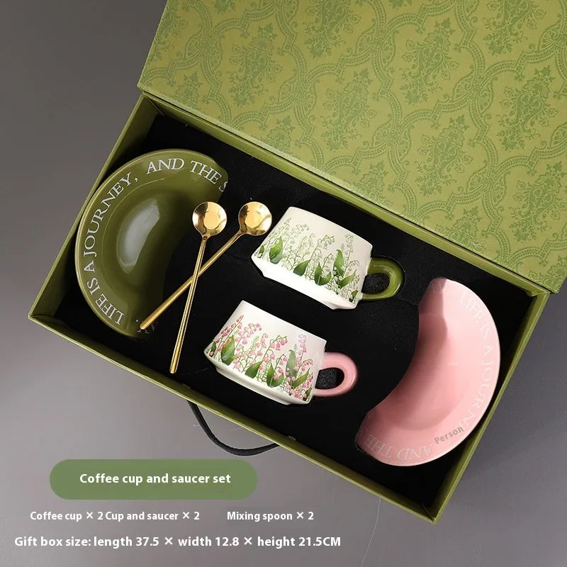 Ceramic coffee cup and saucer set for two people with stirring spoons