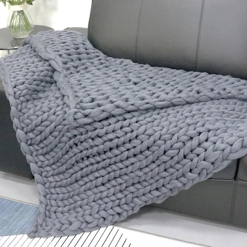 Hand woven chenille blanket in dark grey colour draped over a sofa, available in multiple sizes